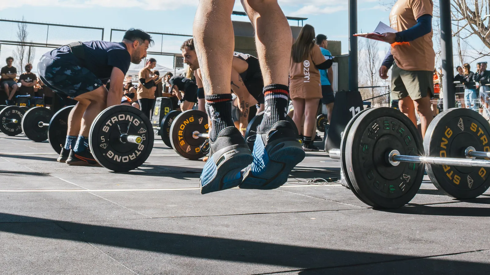 Athlète soulevant une barre lestée pendant un WOD dans une box de CrossFit à Toulouse